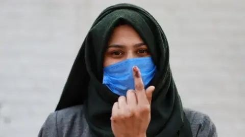 Getty Images First time voter Iram after casting her vote in on 1 December 2020.