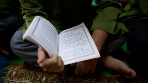 Getty Images Boy reading a Koran