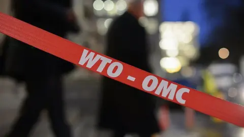 Getty Images Barrier with the WTO-OMC sign on it