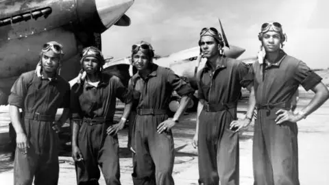 Tuskegee Airmen at Tuskegee Army Flying School, with fighter aircraft, Tuskegee, Alabama, 1942