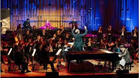 KCCUK Jung and the orchestra performing with traditional Korean musicians
