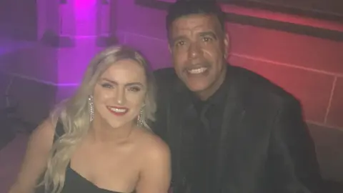 Family photo Helen Fincham meeting Chris Kamara at an event