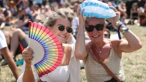 PA Media Two women at Glastonbury