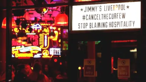 Reuters Sign reading "Jimmy's Liverpool - Cancel The Curfew - Stop Blaming Hospitality"