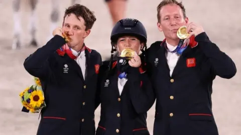 Reuters Gold medallists Oliver Townend of Britain, Laura Collett of Britain and Tom McEwen of Britain celebrate. REUTERS/Molly Darlington