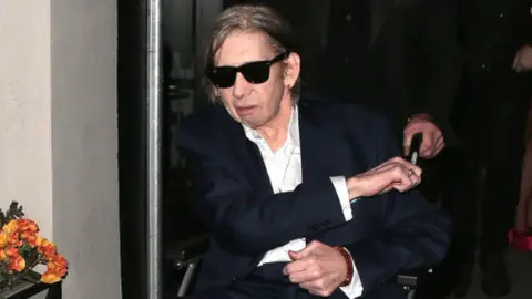 Getty Images Shane MacGowan in a wheelchair