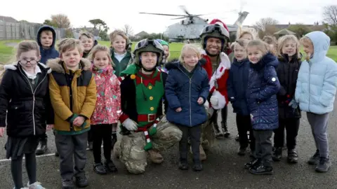 RNAS Culdrose Royal Navy observer Lt Aren Tingle and Lt Emma Turner with schoolchildren