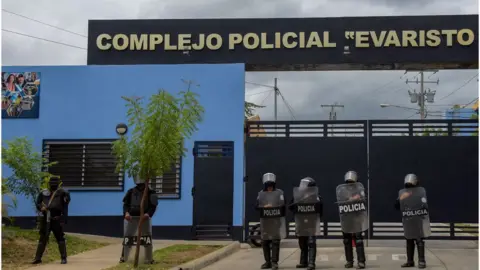 AFP Riot police stand guard outside the Evaristo Vasquez Police Complex, known as "El Chipote", where Nicaraguan pre-presidential candidate Juan Sebastian Chamorro remains detained, in Managua on June 30, 2021.