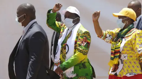 EPA Emmerson Mnangagwa greeting supporters during ZANU PF campaign launch