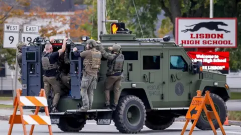 Reuters Armed police on a vehicle in a neighbourhood