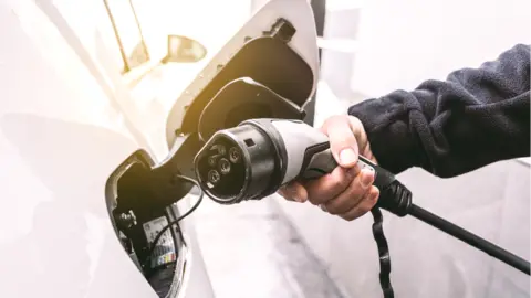 Getty Images Electric car with plug