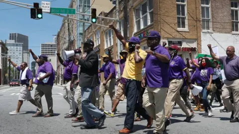 Getty Images Image shows Crump leading a march in Atlanta, Georgia