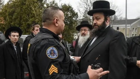 Getty Images Men outside rabbi's house