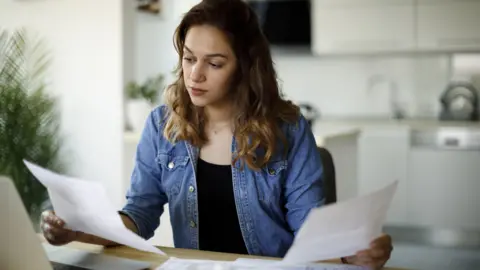 Woman looking at bills