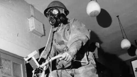 Getty Images Tests were carried out at Porton Down over decades - here a soldier tests PPE in 1964 by pedalling on an exercise bike