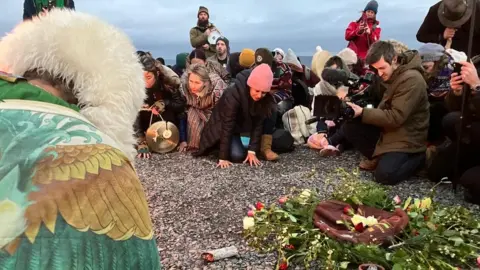 People celebrating winter solstice at Glastonbury Tor