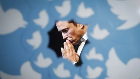 Getty Images An image of new Twitter owner Elon Musk is seen surrounded by Twitter logo