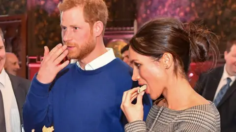 Getty Images Prince Harry and Meghan Markle enjoy a Welsh cake