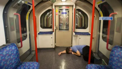 Getty Images Man sleeping on Night Tube