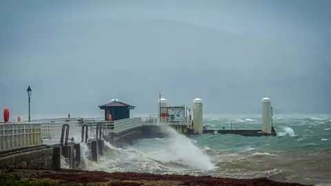 BBC Weather Watchers/Ani-Caul waves sweep over a pier Beaumaris