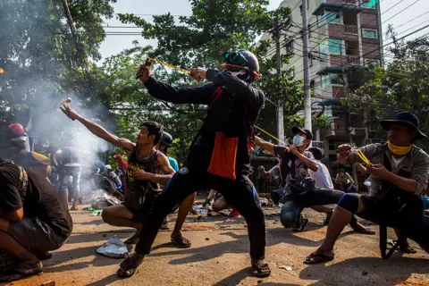 Anonymous taken for The New York Times Protesters use slingshots and other homemade weapons in a clash with security forces in Yangon, Myanmar