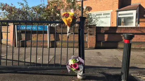 PA Flowers left at scene in Randlesdown Road in Bellingham, south-east London