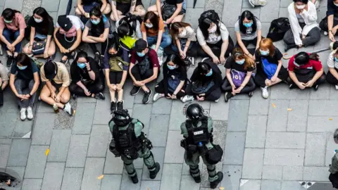 AFP Riot police detain a group of people during a protest in the Causeway Bay district of Hong Kong