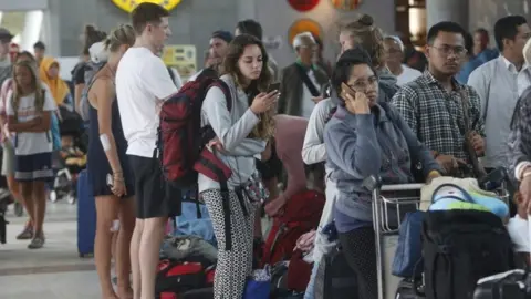 EPA People waiting to check in at Praya International airport in Lombok