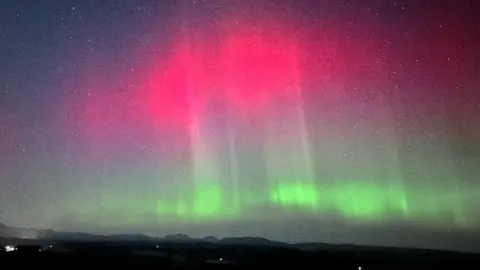 BBC WEATHER WATCHERS / CAMBUS BOOLER Red and green colours in the night sky