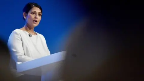 Getty Images Priti Patel speaking at the Conservative Party autumn conference in Manchester