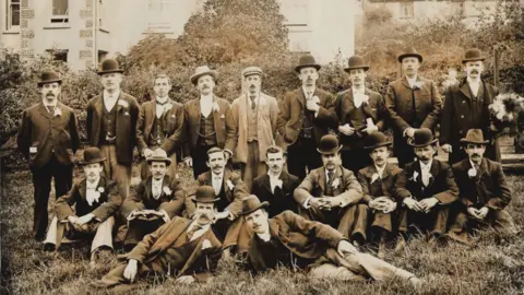 Beaufort male choir An old black and white picture of men all in hats and suits