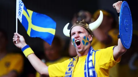 Getty Images A Swedish football fan watches the national team play Russia