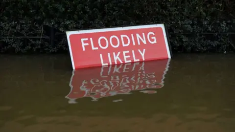 A flood warning sign from the 2020 floods in Shrewsbury, Shropshire