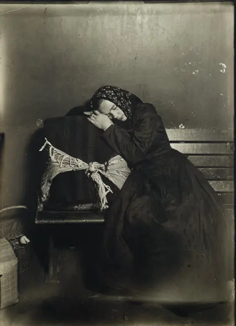 Courtesy of Swann Auction Galleries An immigrant sleeps on her case.