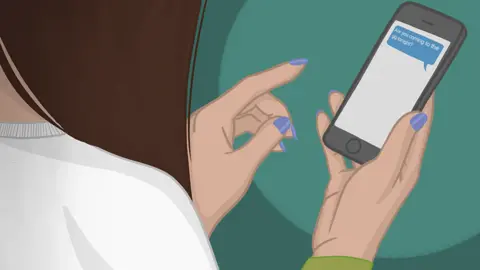 A woman looks at her phone