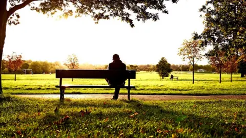 Google Man sitting on park bench