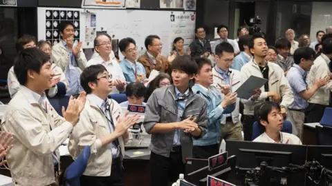 AFP / ISAS-JAXA Japanese scientists celebrating