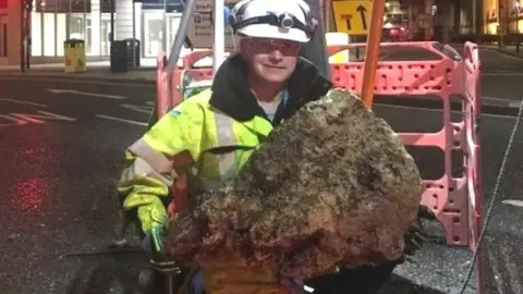 A mass of wet wipes being removed from a sewer