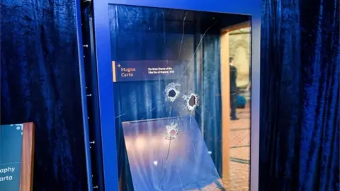 PA Media Hammer holes in the glass case that houses the Magna Carta