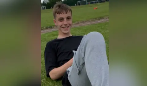 Family handout Tomasz smiles at the camera