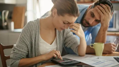 Couple looking at a calculator