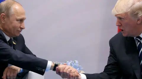 Reuters Vladimir Putin shaking hands with Donald Trump