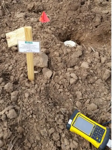 Elizabeth Cochran A small hole in the earth with a white sensor