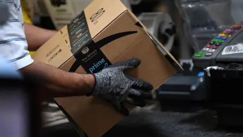 Reuters Worker assembles a box for delivery at the Amazon fulfilment centre in Baltimore, Maryland