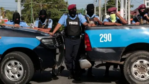 Reuters Police block the entrance of Divine Mercy Catholic Church in Managua, Nicaragua July 14, 2018.