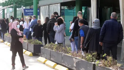 Reuters People queue to enter a supermarket amid the coronavirus disease (COVID-19) outbreak in Beirut, Lebanon (11 January 2021)