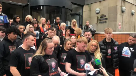 BBC/Corinne Wheatley Family and friends of Alfie Lewis outside court