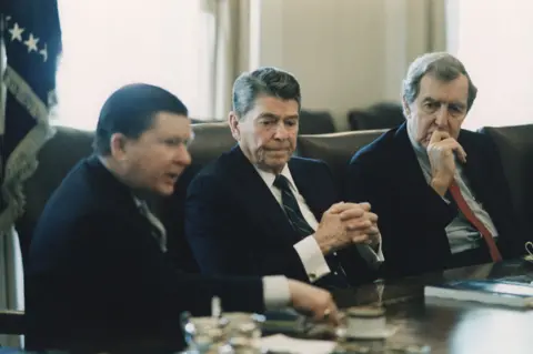 Alamy Ronald Reagan receives Iran-Contra report