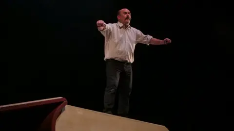 Thomas McQuillan Paul Garret as David Ervine on stage