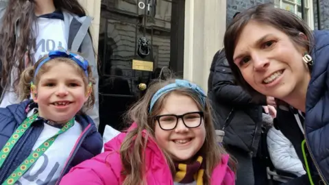 Family photo Emily went to Downing Street with her mum, Louise, and sister Grace